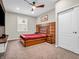 Spacious main bedroom features a ceiling fan, large window, and accent headboard at 6044 Shallow Crk Ln, Indianapolis, IN 46237