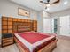 Spacious main bedroom with decorative accent headboard, ceiling fan, and ensuite bathroom at 6044 Shallow Crk Ln, Indianapolis, IN 46237