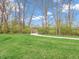 Peaceful walking path winding through green grass and mature trees at 6044 Shallow Crk Ln, Indianapolis, IN 46237