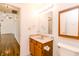 Bathroom featuring tiled floors, oak vanity, and a view into a carpeted living room at 6315 Hansbrough Way, Indianapolis, IN 46268