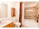 Well-lit bathroom featuring tiled floors, a tub, and an oak vanity with countertop at 6315 Hansbrough Way, Indianapolis, IN 46268