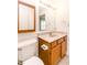 Bathroom featuring tiled floors, an oak vanity, a large mirror, and a toilet at 6315 Hansbrough Way, Indianapolis, IN 46268