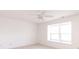 Minimalist bedroom with neutral carpet features a large window and a ceiling fan at 6315 Hansbrough Way, Indianapolis, IN 46268