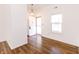 Bright entryway with hardwood floors and a freshly painted white front door at 6315 Hansbrough Way, Indianapolis, IN 46268
