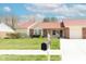 Charming single-story home featuring a well-manicured lawn and classic brick accents at 6315 Hansbrough Way, Indianapolis, IN 46268