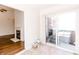 Open view from sunroom into a living room with a fireplace and wood flooring at 6315 Hansbrough Way, Indianapolis, IN 46268