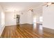 Open-concept living room featuring hardwood floors, ceiling fans, and ample natural light at 6315 Hansbrough Way, Indianapolis, IN 46268