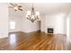 Inviting living room featuring hardwood floors, fireplace, and modern ceiling fan at 6315 Hansbrough Way, Indianapolis, IN 46268