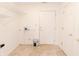 Bright mud room featuring tile flooring, wire rack shelving, and white doors at 6315 Hansbrough Way, Indianapolis, IN 46268