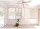 Bright sunroom features tile flooring, large windows with blinds, and ceiling fan at 6315 Hansbrough Way, Indianapolis, IN 46268
