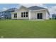 Expansive backyard with lush green lawn and sliding glass door leads inside at 6474 Ambassador Dr, Plainfield, IN 46168