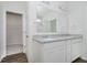 Well-lit bathroom featuring dual sinks, granite countertops, and a spacious walk-in closet at 6474 Ambassador Dr, Plainfield, IN 46168