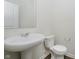 Comfortable half-bathroom features a large white sink and matching toilet at 6474 Ambassador Dr, Plainfield, IN 46168