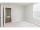 Bedroom with neutral carpet, white walls, window, and access to an adjacent room at 6474 Ambassador Dr, Plainfield, IN 46168