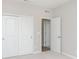 Bedroom with carpet flooring, white closet doors, and adjoining rooms at 6474 Ambassador Dr, Plainfield, IN 46168