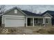 Charming single-story home with a two-car garage and covered front porch at 6474 Ambassador Dr, Plainfield, IN 46168