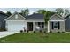 Charming single-story home featuring stone accents, a two-car garage, and a well-manicured front lawn at 6474 Ambassador Dr, Plainfield, IN 46168