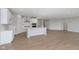 Bright open-concept living room, dining room and kitchen with hardwood floors and recessed lighting at 6474 Ambassador Dr, Plainfield, IN 46168