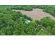 An aerial perspective shows a house nestled among trees, accompanied by vast tracts of land and winding roads at 685 N Buffalo Hill Rd, Martinsville, IN 46151