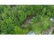 Aerial view of a pond surrounded by lush green trees at 685 N Buffalo Hill Rd, Martinsville, IN 46151