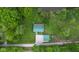 An aerial view of the house showing the green roof, surrounding trees, and nearby body of water at 685 N Buffalo Hill Rd, Martinsville, IN 46151