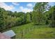 Backyard with green grass and wooded area with a shed at 685 N Buffalo Hill Rd, Martinsville, IN 46151