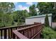 Backyard featuring a wooden deck with green shrubs and multiple trees at 685 N Buffalo Hill Rd, Martinsville, IN 46151