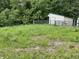 Exterior of a Morton barn and fenced area surrounded by a field and lush trees at 685 N Buffalo Hill Rd, Martinsville, IN 46151
