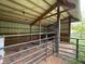 Interior of a barn showcasing the wooden beam construction, metal roof and fencing for livestock at 685 N Buffalo Hill Rd, Martinsville, IN 46151