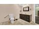 Bathroom featuring a toilet with handrail, dark vanity, mirror, and tile flooring at 685 N Buffalo Hill Rd, Martinsville, IN 46151