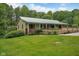 Charming home featuring a metal roof, inviting front porch, and a spacious landscaped yard at 685 N Buffalo Hill Rd, Martinsville, IN 46151