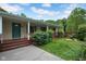 Covered front porch featuring a green front door, wooden railings, and a small patio space at 685 N Buffalo Hill Rd, Martinsville, IN 46151