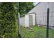 Exterior shot of a shed with a chicken wire fence and green grass at 685 N Buffalo Hill Rd, Martinsville, IN 46151