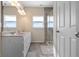 Bright bathroom boasts double sinks, spacious countertops, and a modern tiled glass shower at 7067 Hart St, Cumberland, IN 46229