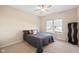 Neutral bedroom with cozy carpet, ceiling fan and a large window at 7067 Hart St, Cumberland, IN 46229