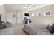 Bright bedroom features neutral walls, ceiling fan, a desk, and a large window overlooking the property at 7067 Hart St, Cumberland, IN 46229