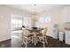 Cozy dining area with wood floors, modern chandelier, and bright windows for enjoyable meals at 7067 Hart St, Cumberland, IN 46229
