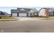 Charming one-story home with a three car garage, neutral siding, and a well manicured lawn at 7067 Hart St, Cumberland, IN 46229
