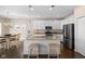 Bright eat-in kitchen features white cabinets, granite countertops, stainless appliances and a large center island at 7067 Hart St, Cumberland, IN 46229
