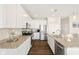 Modern kitchen with stainless appliances, granite countertops, white cabinetry and a large island at 7067 Hart St, Cumberland, IN 46229