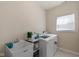Well-lit laundry room with modern washer and dryer, utility sink, and ample storage space at 7067 Hart St, Cumberland, IN 46229