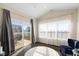 Bright sitting room features a ceiling fan, vaulted ceiling, and large sliding glass doors to the patio at 7067 Hart St, Cumberland, IN 46229