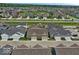 An aerial view showcasing a well-planned residential community with modern homes, green spaces, and roadways at 7092 Cherry Creek Blvd, Carmel, IN 46033