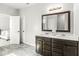 Bathroom with double vanity and large mirror, located just off the main bedroom at 7092 Cherry Creek Blvd, Carmel, IN 46033