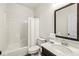 Bathroom featuring a shower, toilet, and a dark wood vanity with quartz countertop and decorative mirror at 7092 Cherry Creek Blvd, Carmel, IN 46033