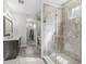 Elegant bathroom featuring a large walk-in shower with glass door, double vanity and tile floor at 7092 Cherry Creek Blvd, Carmel, IN 46033