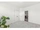 Bright bedroom with white walls, plush carpet, closet and an open doorway leading to another room at 7092 Cherry Creek Blvd, Carmel, IN 46033