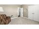 Neutral bedroom with large window, closet, plush carpet and a cozy armchair perfect for relaxation at 7092 Cherry Creek Blvd, Carmel, IN 46033