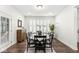 Modern dining room with dark wood flooring and a window with white shutters at 7092 Cherry Creek Blvd, Carmel, IN 46033