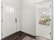 The foyer of a home, leading to a sunlit room with an adjacent front door at 7092 Cherry Creek Blvd, Carmel, IN 46033